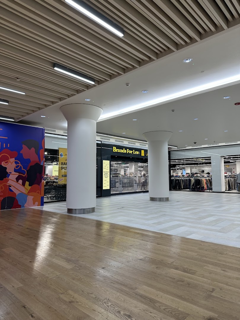 The exterior of the Brands For Less store in Granada Mall, featuring its prominent signage and display windows.