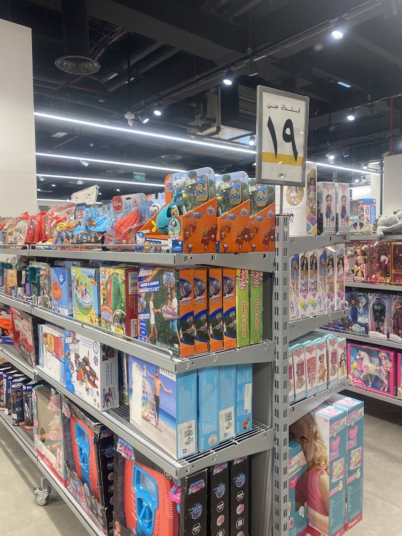 Shelves stocked with a wide variety of toys and games, including dolls, action figures, and outdoor play items.