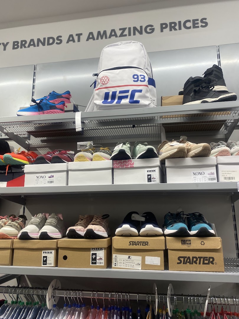 Shelves display various athletic shoes and a UFC backpack, with a sign advertising "Brands at Amazing Prices."