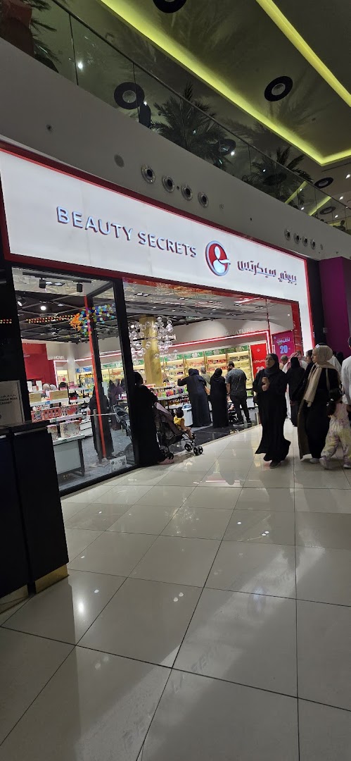 The exterior of the Beauty Secrets shop, showcasing its bright signage and interior displays.