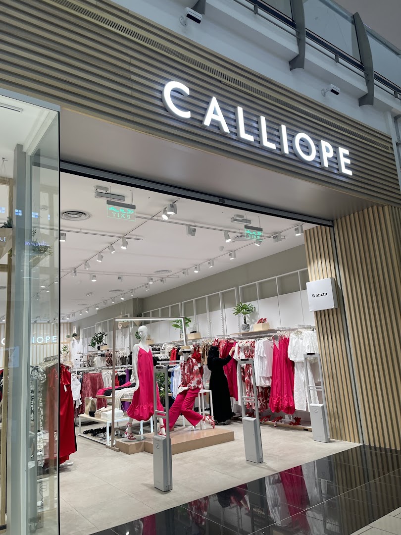 The Calliope store entrance displays mannequins and racks of women's clothing, primarily in red and pink hues.