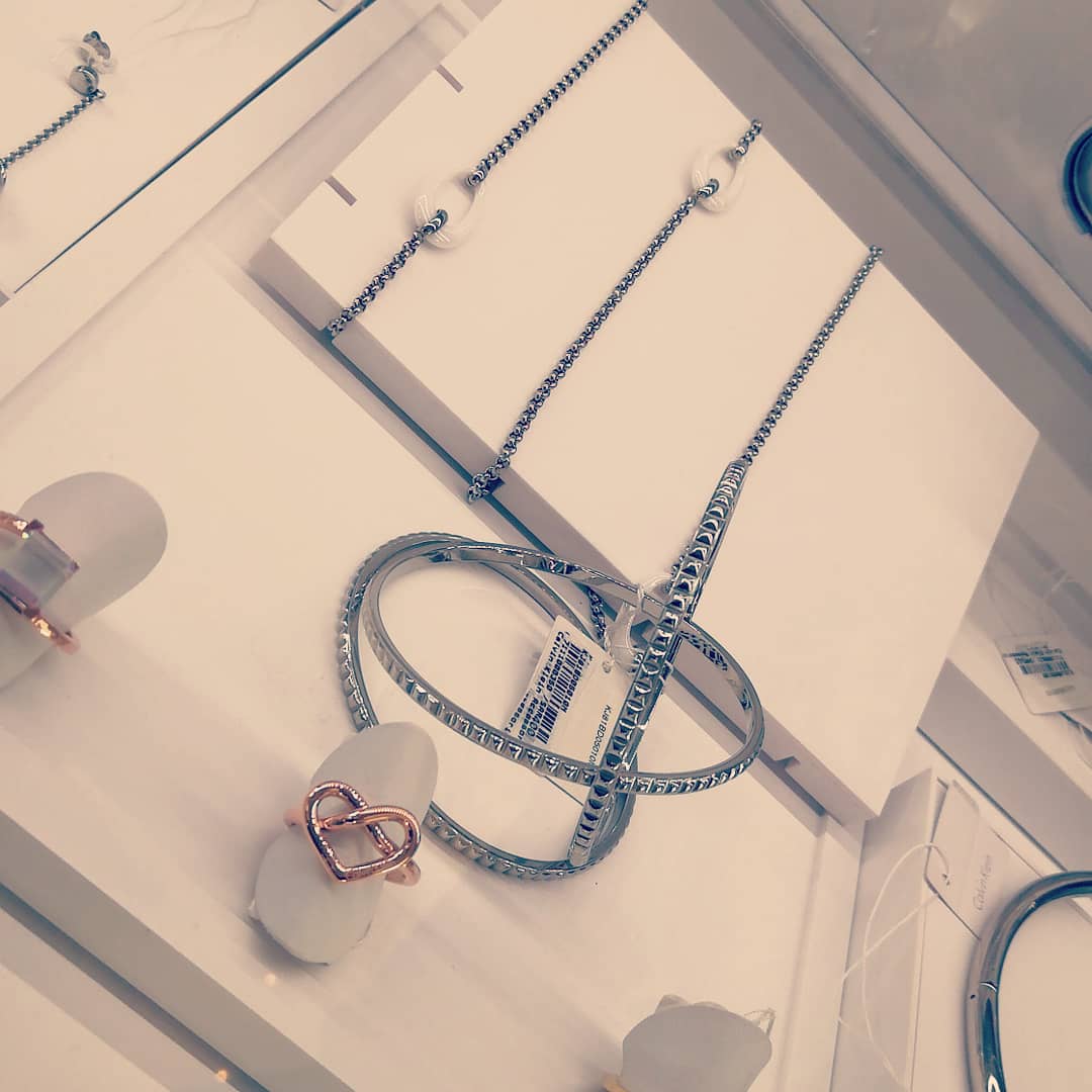 A display of Calvin Klein jewelry, featuring rings and bracelets with elegant designs.