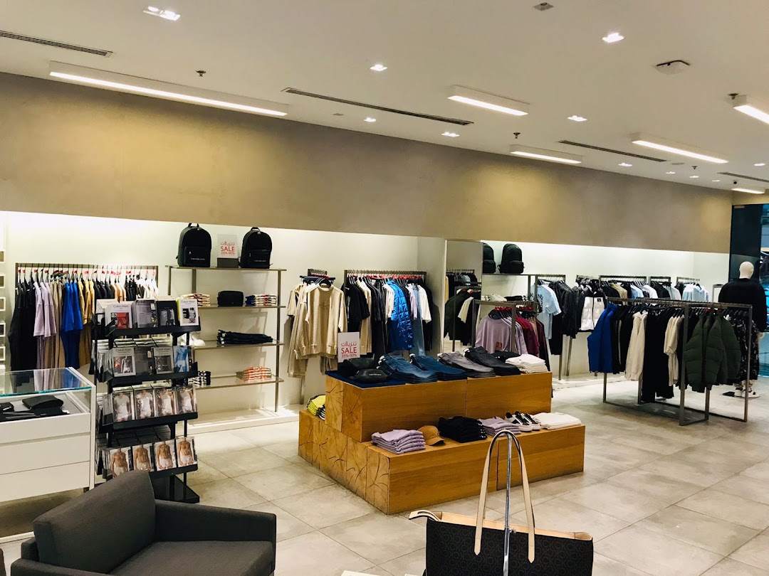 Interior view of a Calvin Klein store showcasing clothing on racks and displays.