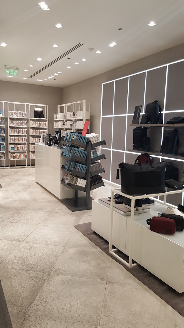 Interior view of a Calvin Klein store showcasing apparel and accessories on display shelves and racks.