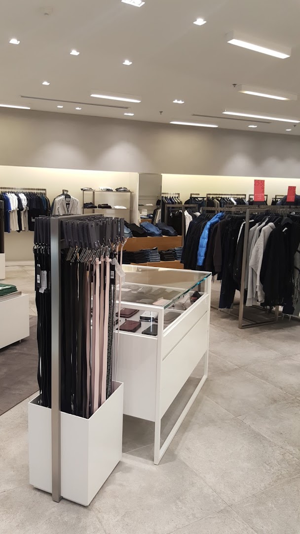 Interior view of a Calvin Klein store showcasing clothing and accessories on display.