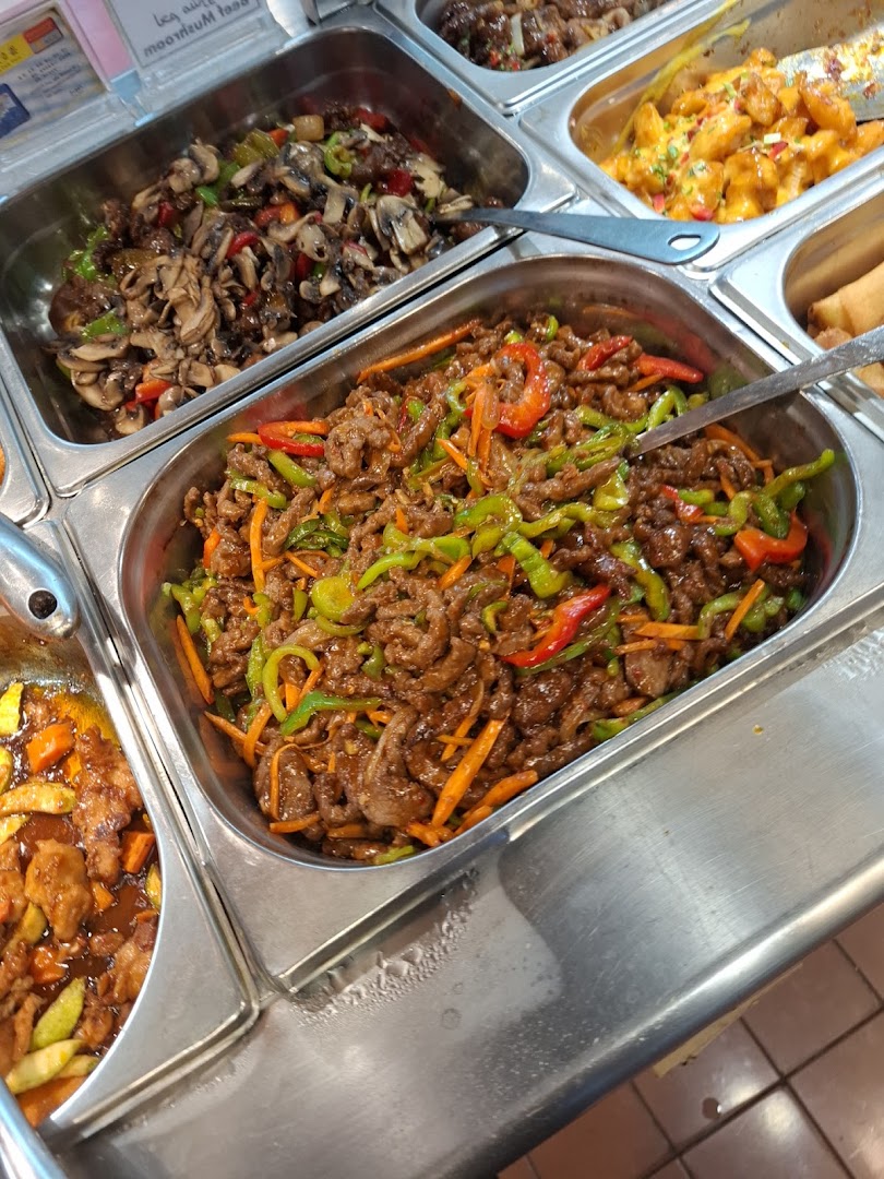 A close-up of several trays of delicious Asian cuisine, featuring stir-fried beef and vegetables.