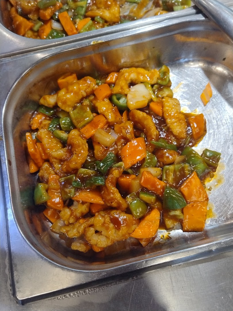 A close-up of a delicious stir-fry dish with chicken, carrots, and bell peppers in a savory sauce.