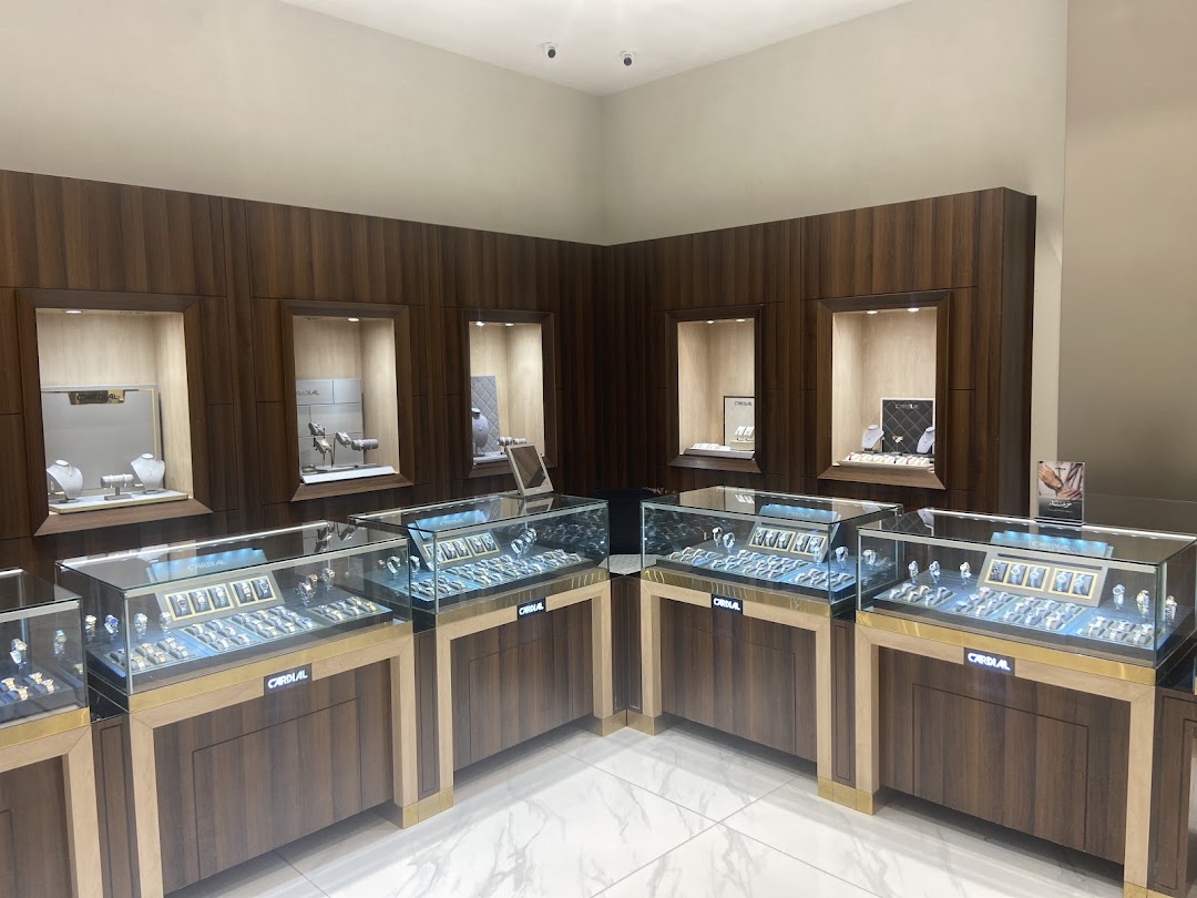 Interior view of a jewelry store with display cases filled with watches and necklaces.