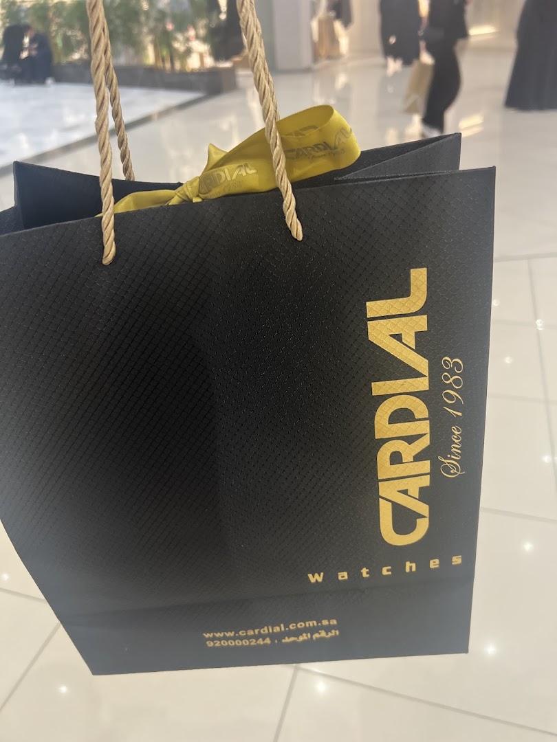 A black shopping bag with gold lettering from the watch store Cardial.