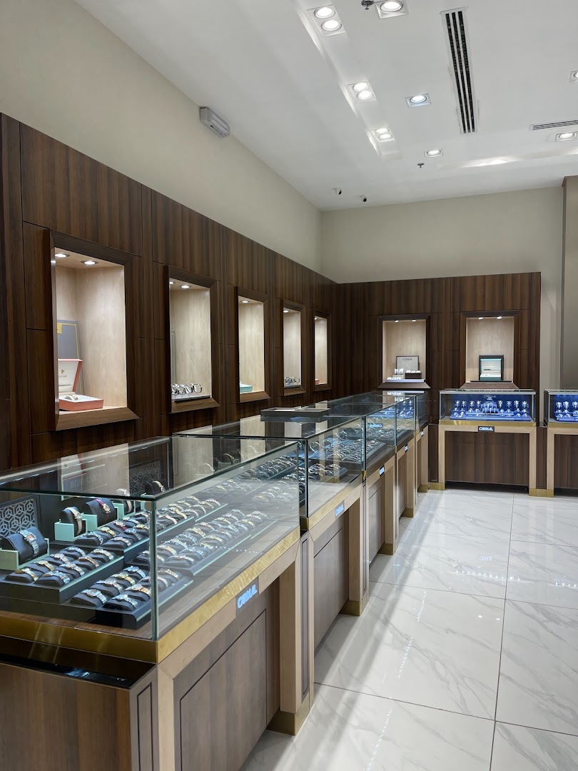 Interior view of a modern watch store with display cases filled with watches.