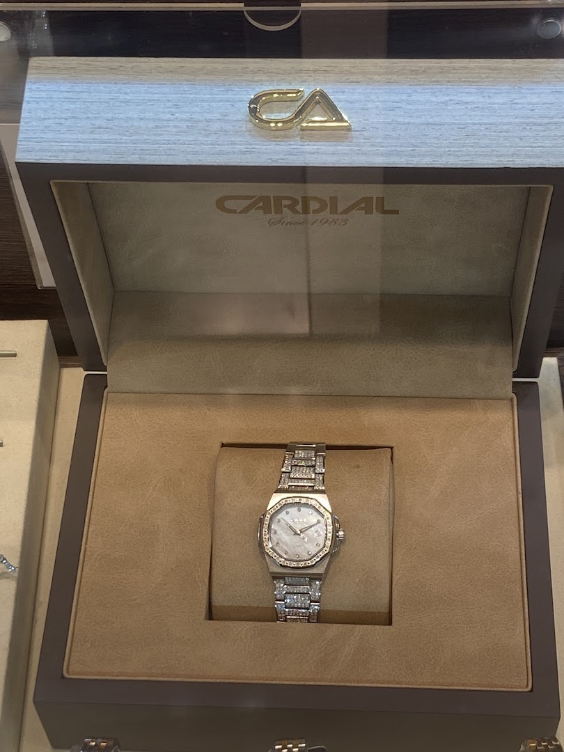 A luxurious Cardial watch with a diamond-encrusted band displayed in its box.