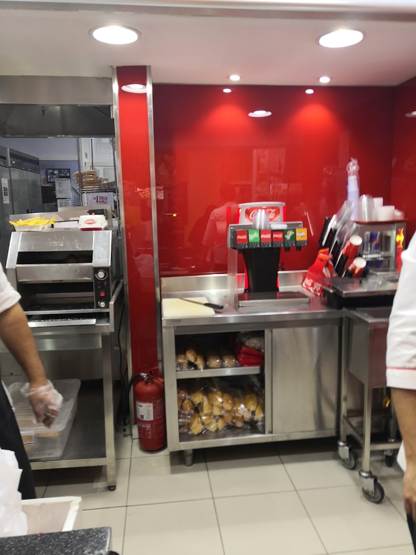 Interior view of a Charleys Cheesesteaks kitchen with food preparation equipment and ingredients.