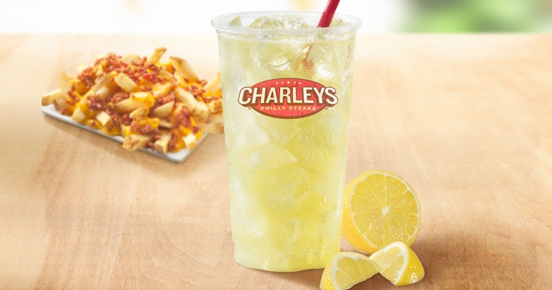 A refreshing lemonade with a side of loaded fries topped with cheese and bacon.