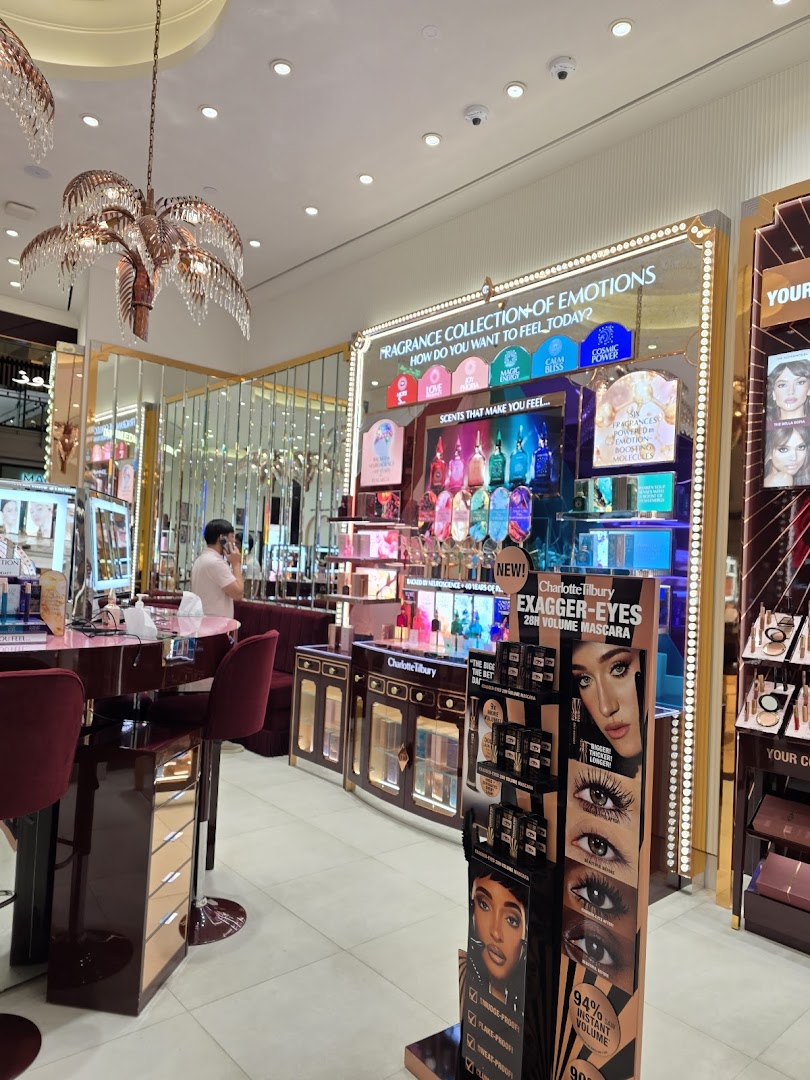 Interior of a Charlotte Tilbury beauty store featuring fragrance displays and mascara promotions.