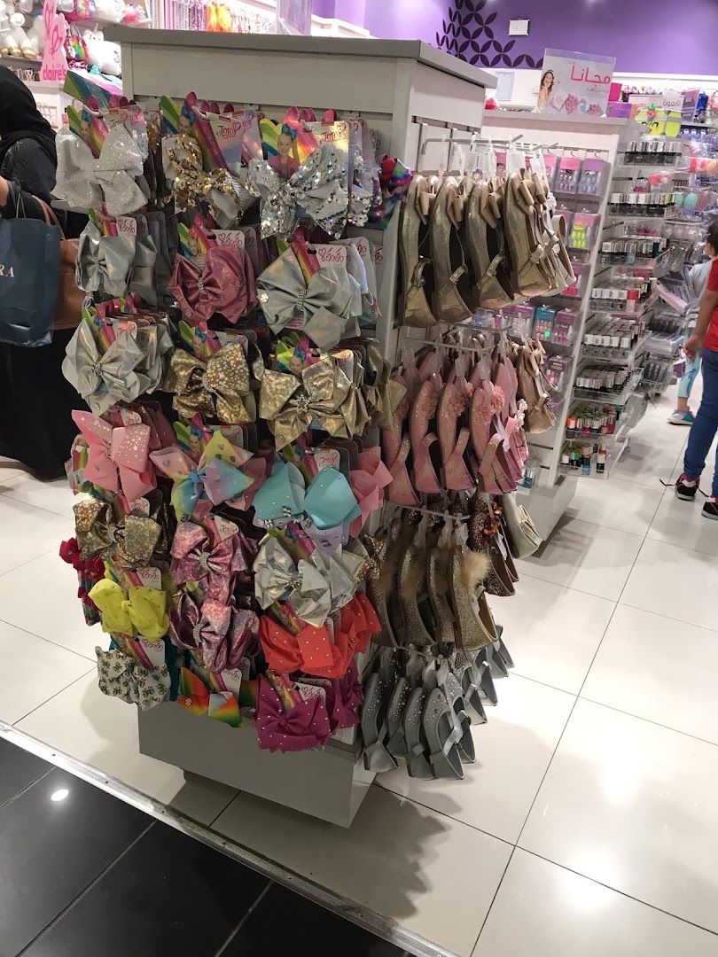 A display of colorful hair bows and sparkly shoes at Claire's.