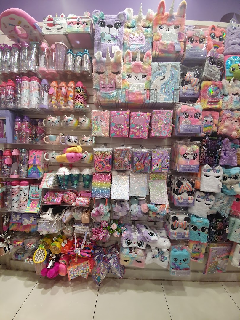 A wall display of colorful and plush notebooks, stationery, and accessories for sale.
