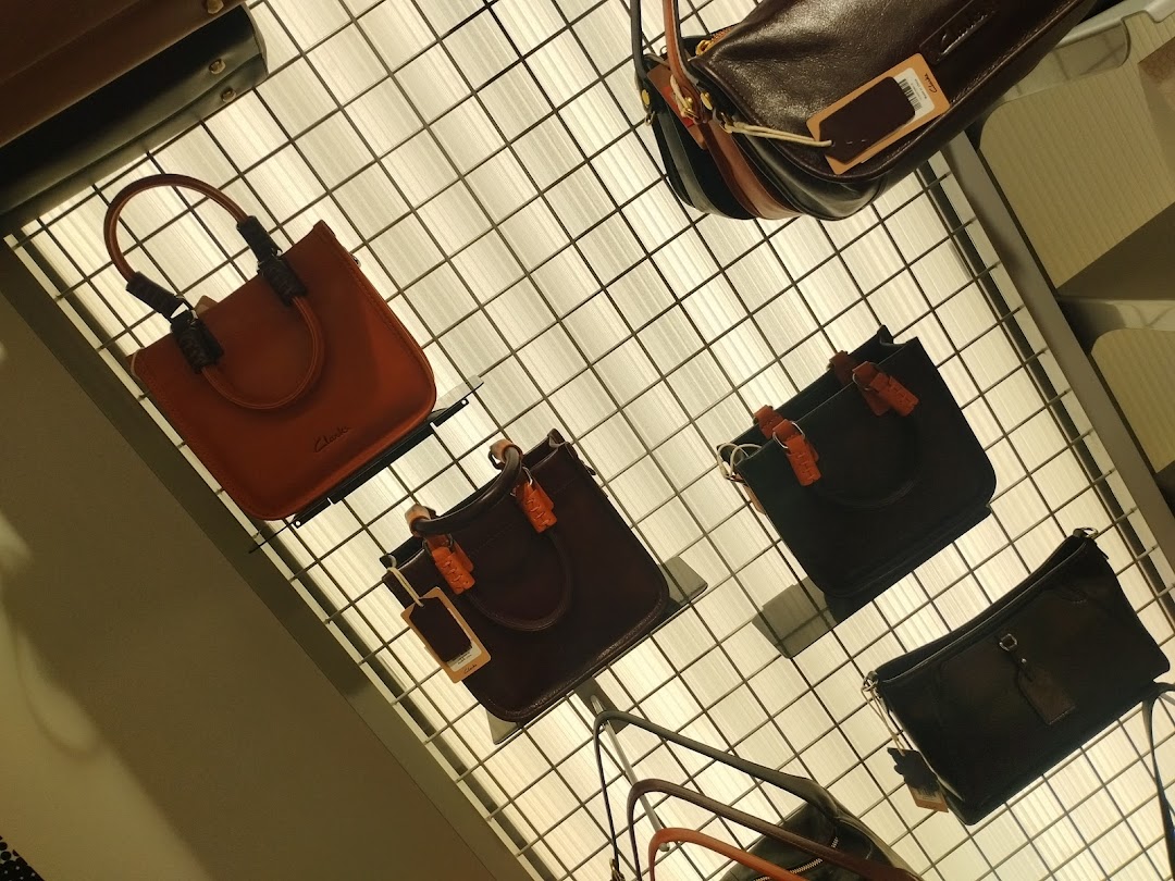 A selection of stylish leather handbags displayed on a grid shelf.
