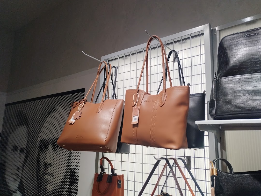 A display of stylish brown and black handbags from Clarks.