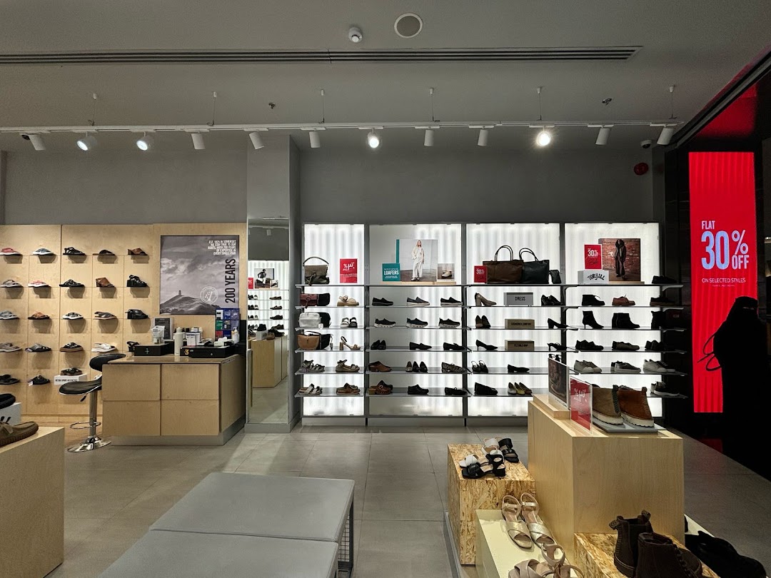 Interior view of a Clarks shoe store showcasing a wide variety of footwear on display.