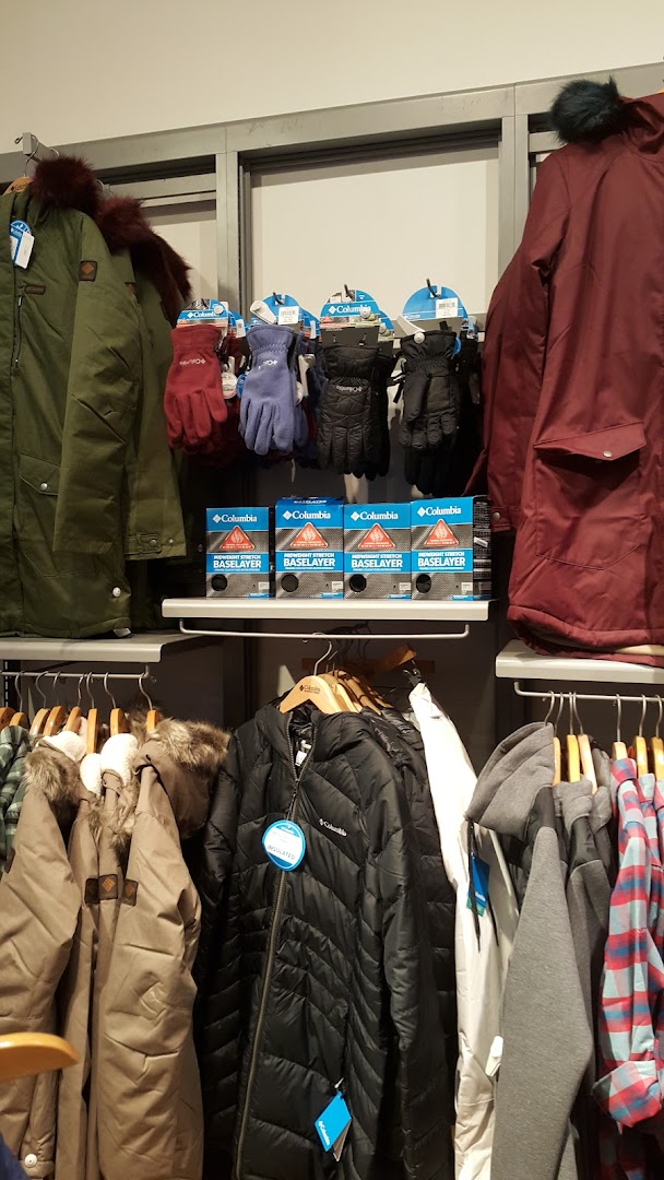 Columbia store display featuring winter jackets, gloves, and base layers.