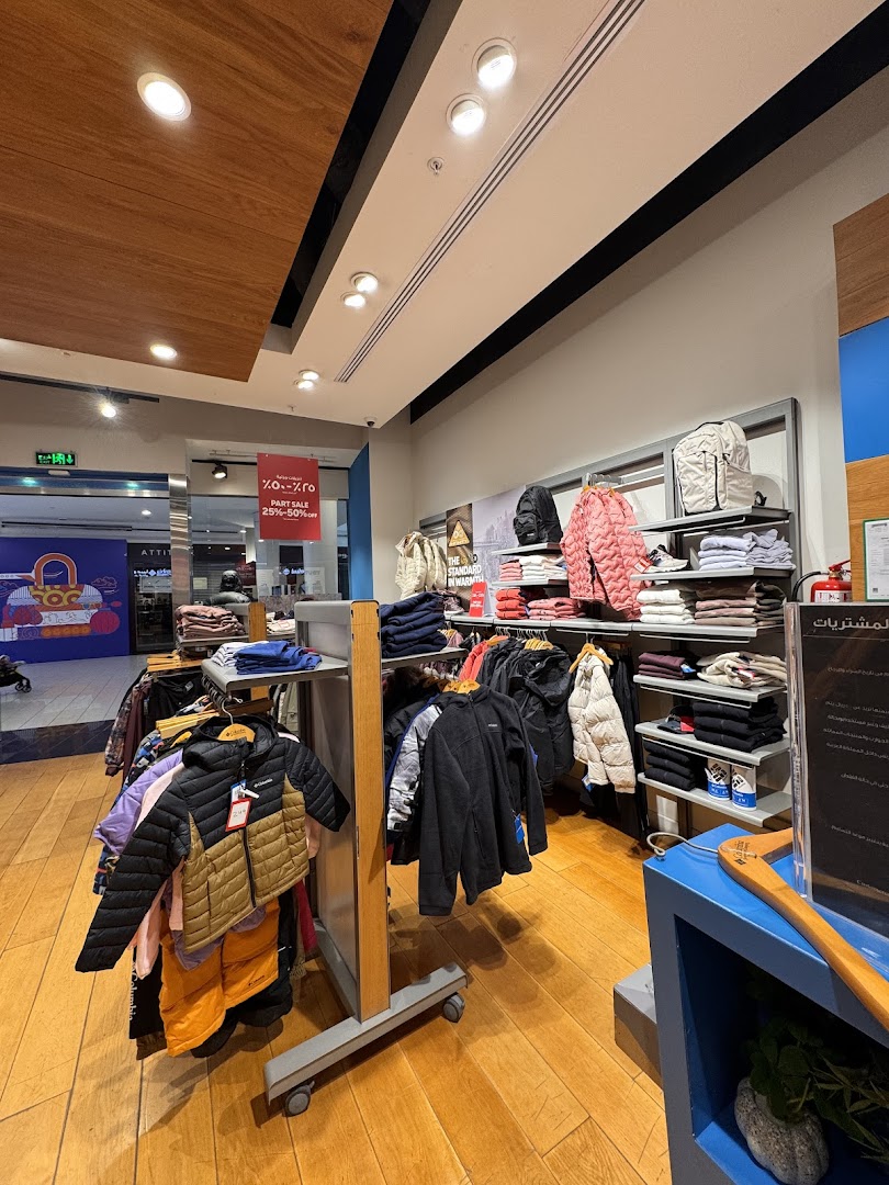 Interior view of a Columbia store showcasing a variety of jackets and apparel on display racks.