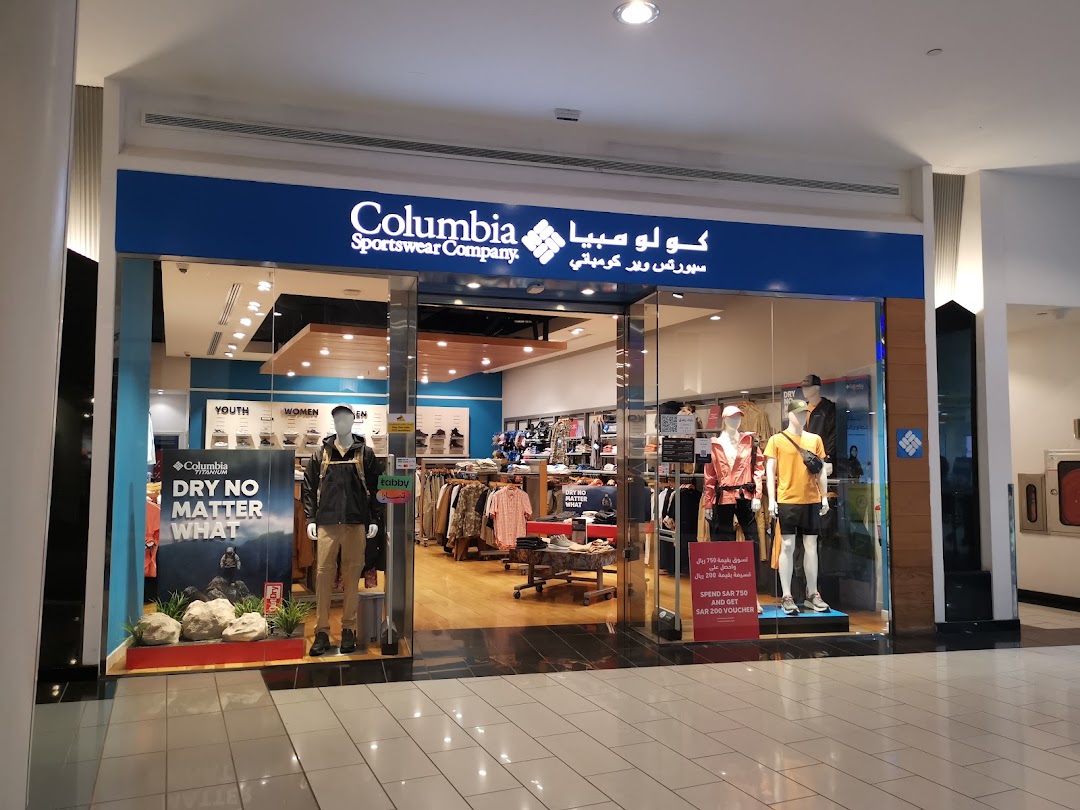 The entrance of a Columbia Sportswear Company store with mannequins and apparel displayed.