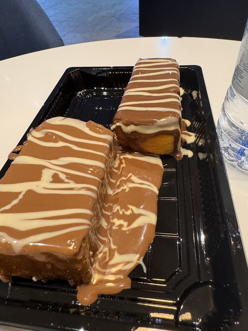 Three rectangular crepes generously drizzled with chocolate and white chocolate sauce.