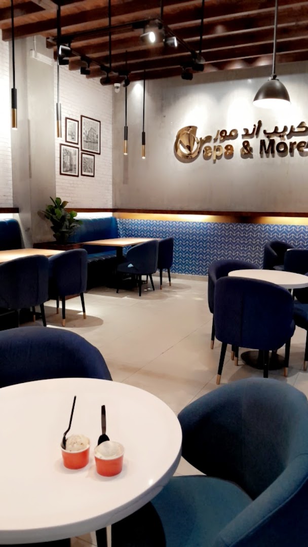 Interior of a modern cafe with blue seating and tables, featuring the shop's logo.