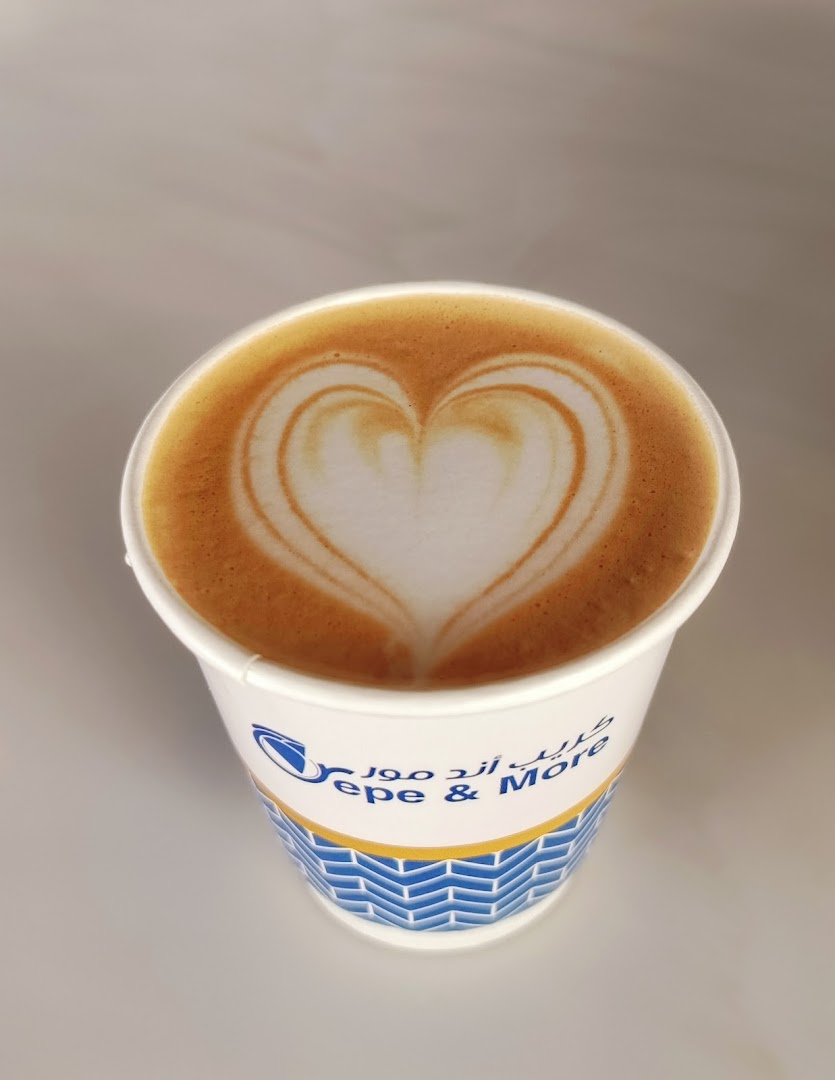 A cup of coffee with latte art in the shape of a heart.