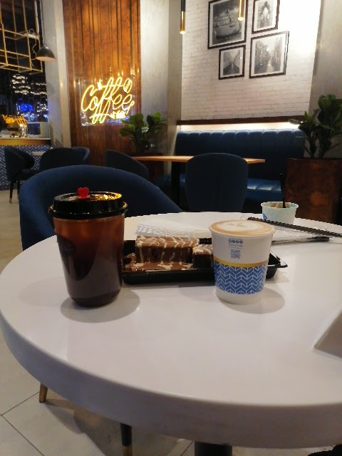 A table at Crepe and More with coffee, dessert, and a drink.