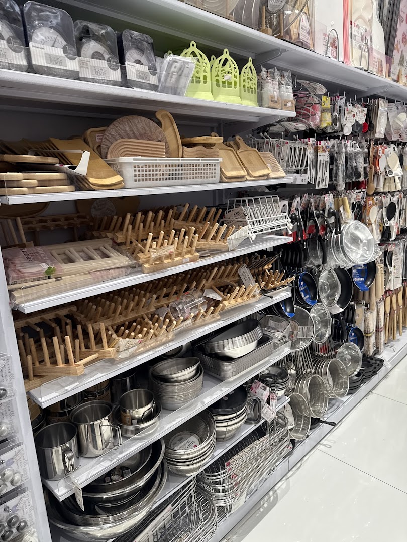 Shelves stocked with kitchenware, including cutting boards, dish racks, pots, and pans.