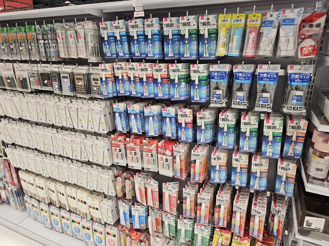 A wide selection of adhesives, glues, and stationery items neatly displayed on shelves.