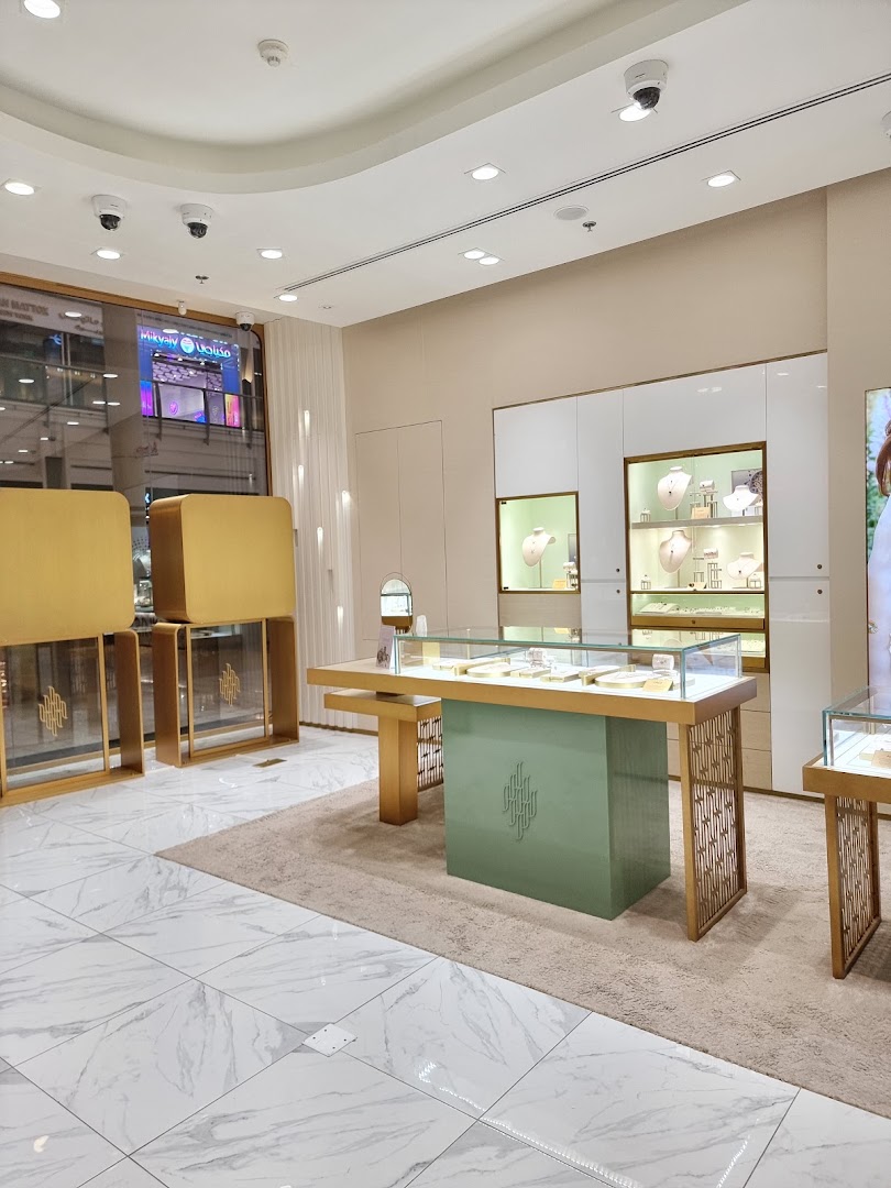 Interior view of a modern jewelry store with display cases and elegant fixtures.