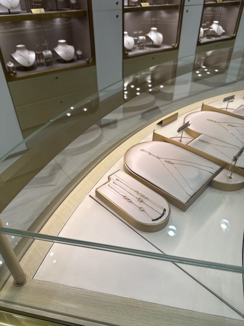 A display of elegant necklaces and bracelets in a well-lit jewelry store.