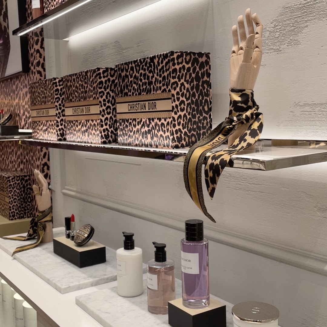 Dior shop interior showcasing leopard print packaging and beauty products.