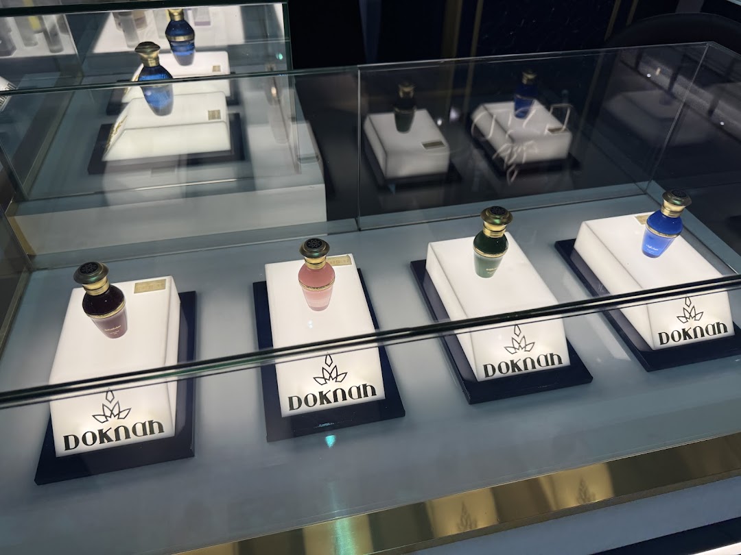 A display case showcasing elegantly bottled perfumes from Doknah.