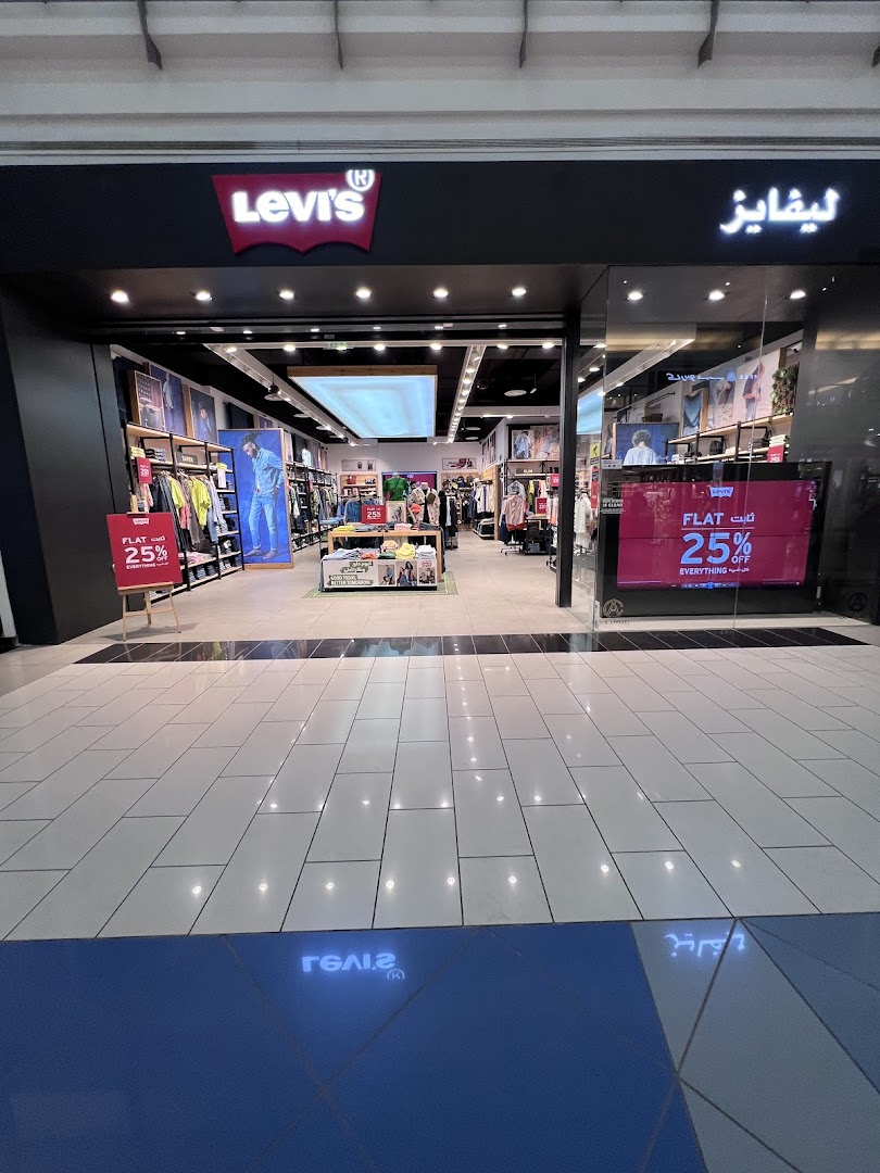 The entrance of a Levi's store with clothing displays and a 25% off sale sign.