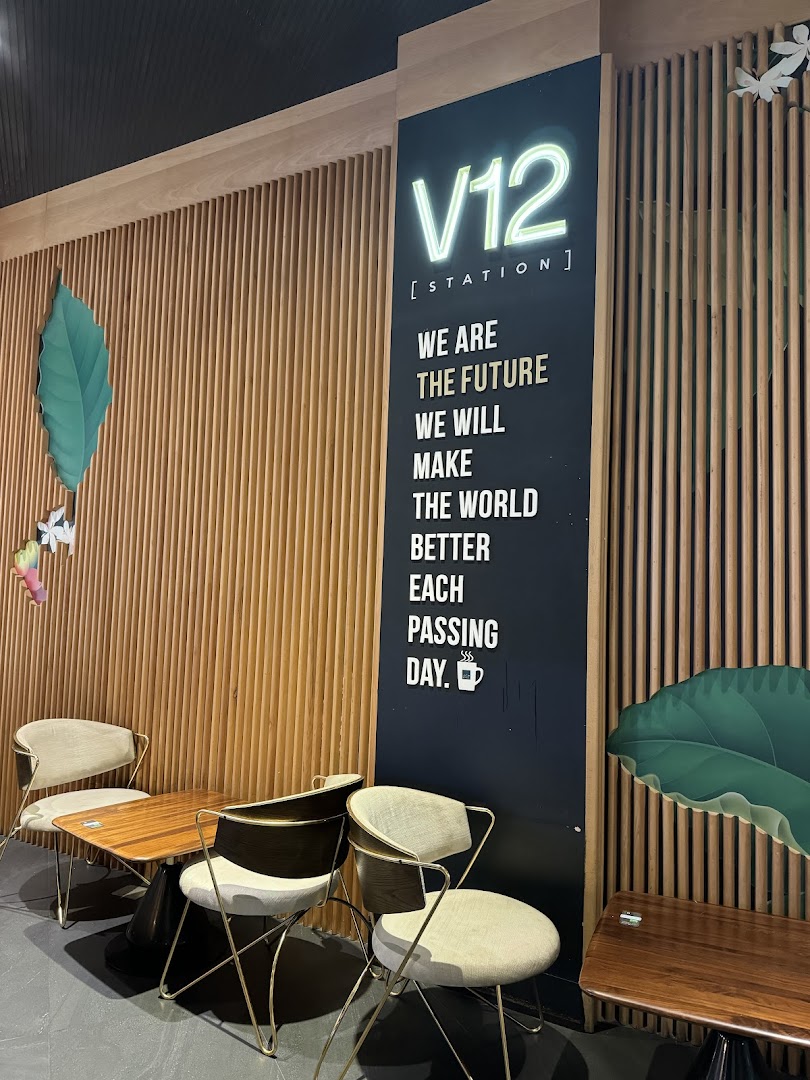 Interior shot of dr.CAFE COFFEE V12 Station with seating and motivational text.