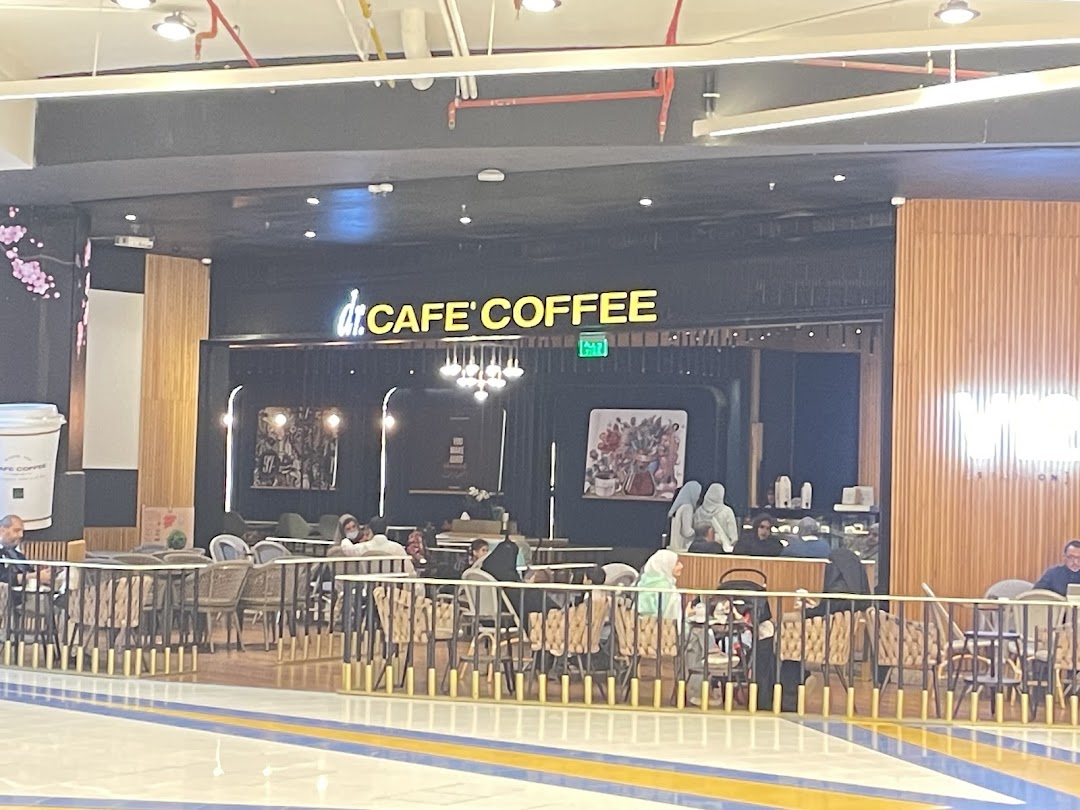The exterior of dr.CAFE COFFEE V12 Station with seating and customers inside.