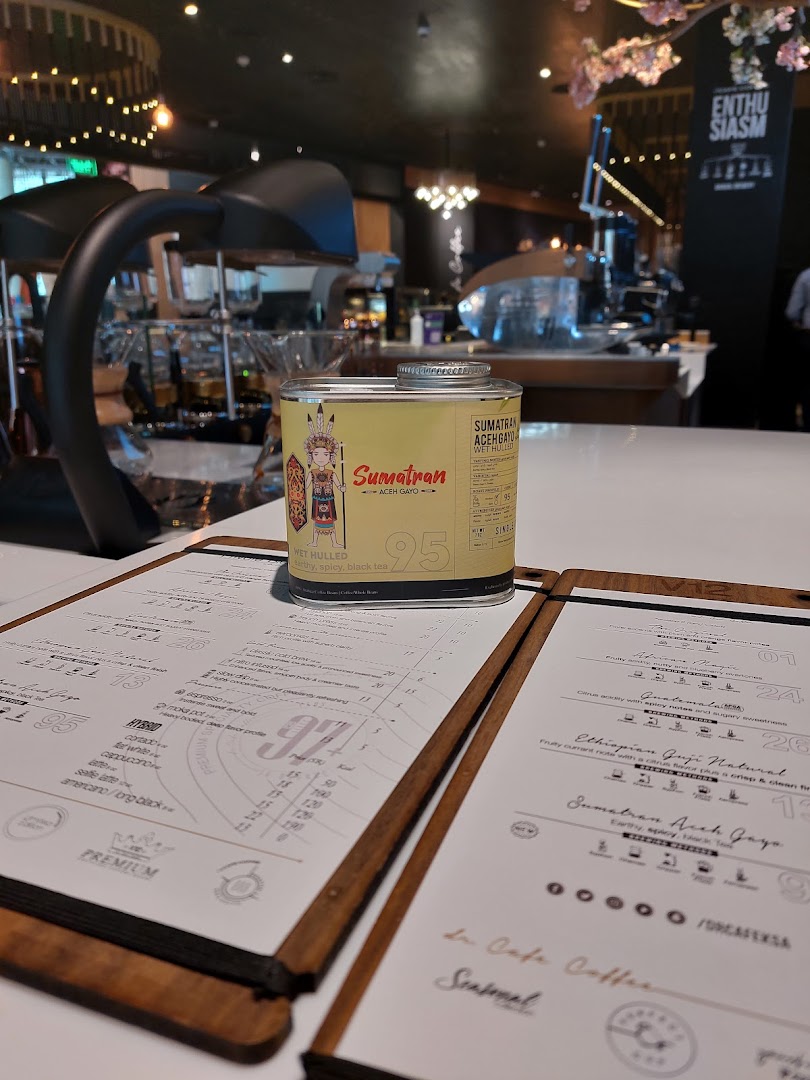 A can of Sumatran Aceh Gayo coffee sits on a menu at dr.CAFE COFFEE V12 Station.