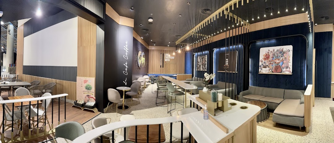 Interior view of a modern coffee shop with comfortable seating and stylish decor.