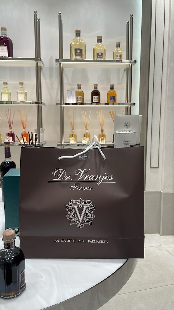 A shopping bag from Dr. Vranjes Firenze with diffuser bottles displayed on shelves.