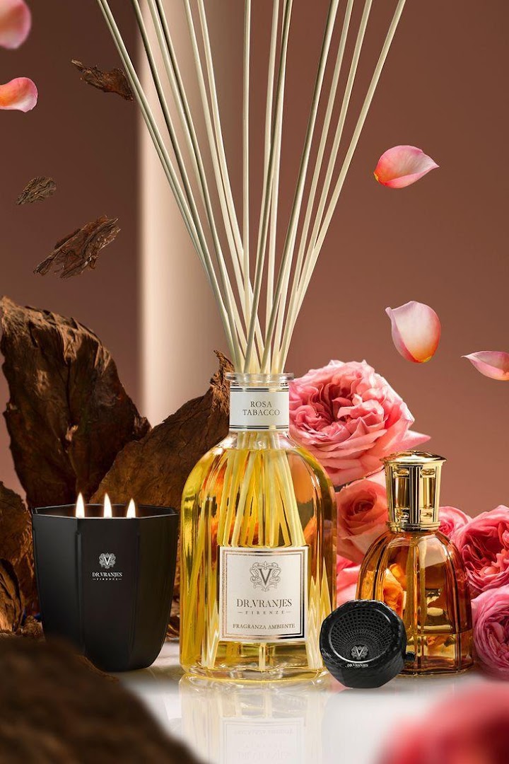 Dr. Vranjes home fragrance products including a diffuser, candle, and smaller diffuser with roses and wood elements.