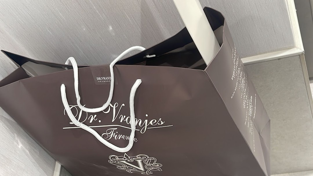 A brown shopping bag with white handles and the Dr. Vranjes Firenze logo.