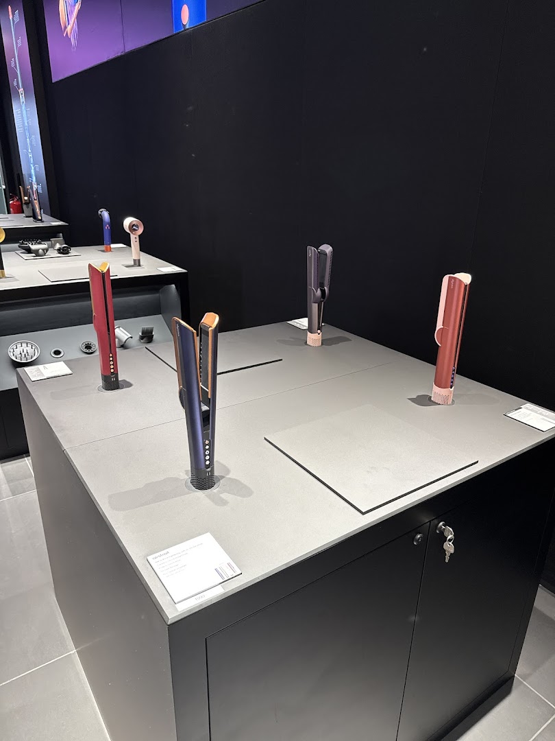 Dyson hair styling tools displayed on a retail store counter.