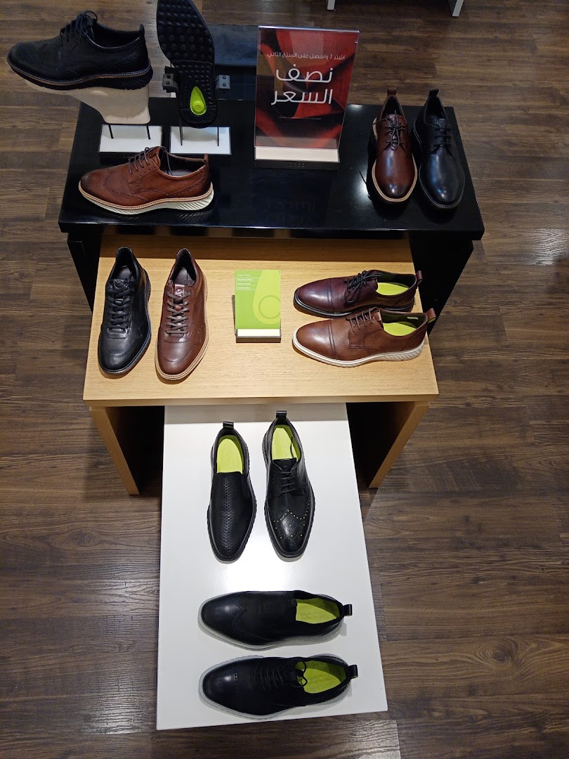 A display of various ECCO leather shoes, including dress shoes and casual styles.
