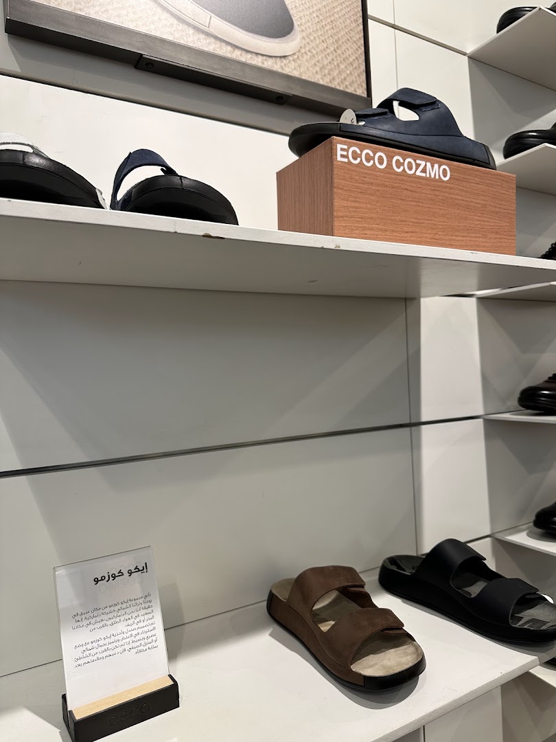 ECCO store interior showcasing various sandals and shoes on display shelves.