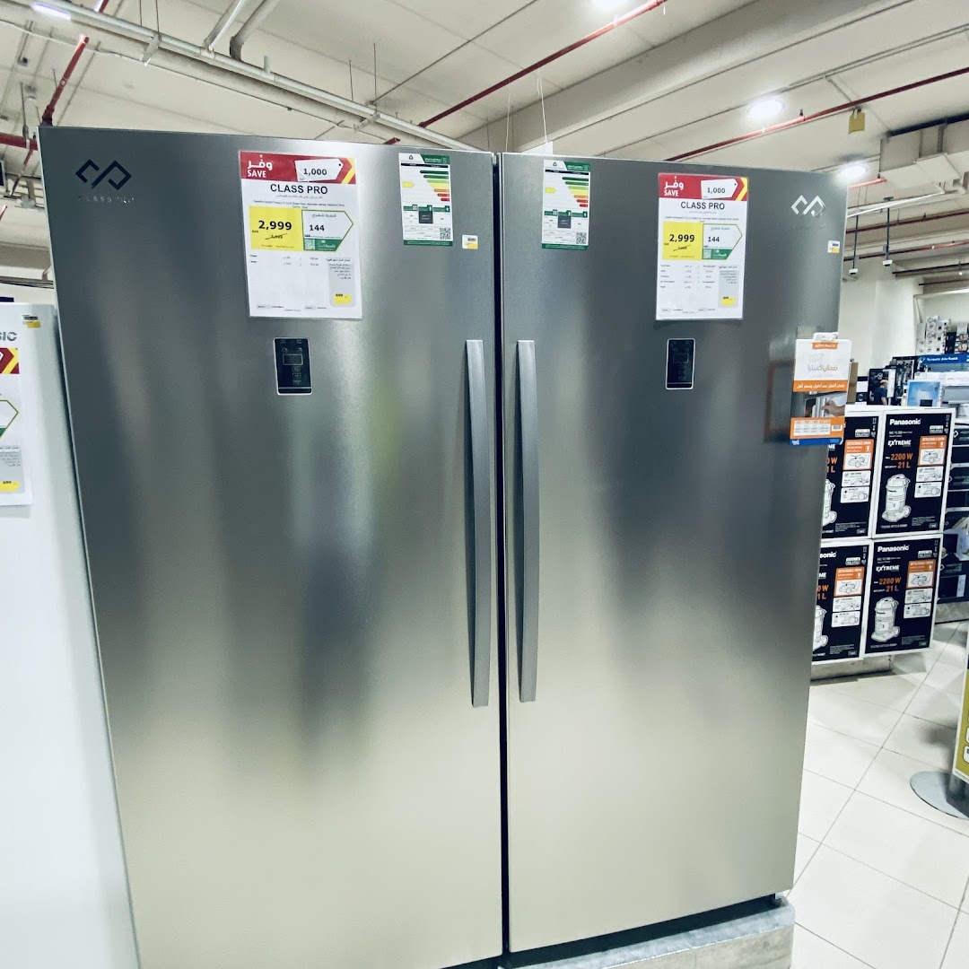 Two large, stainless steel refrigerators are displayed side-by-side with price tags and energy labels.