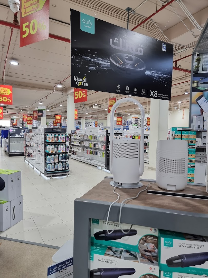 Interior view of an electronics store with promotional banners and product displays.