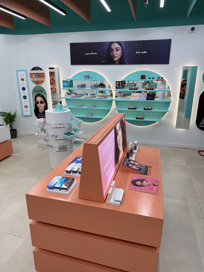 Interior view of an eyewear shop showcasing various sunglasses and optical frames on display.